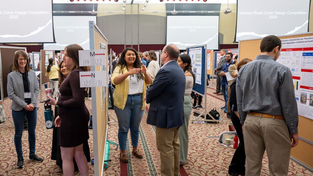Students discuss their research with attendees, faculty and judges.