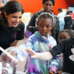 Priyanka Pandit, a Ph.D. student in nuclear engineering, helps students visualize radiation using a cloud chamber.