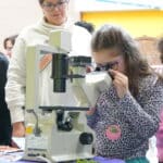 A child looks through a microscope