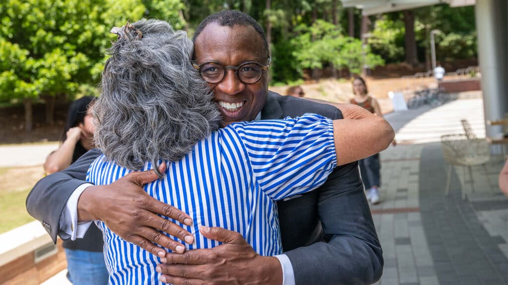Howell hugs a colleague