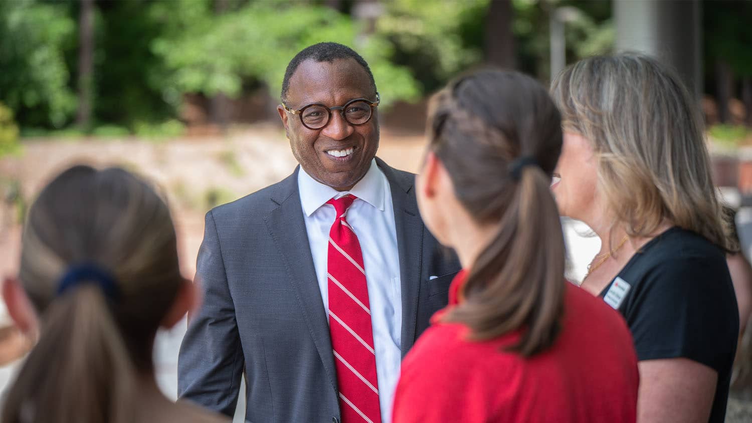 Chancellor Kevin Howell speaks with people at an employee appreciation event on Stafford Commons