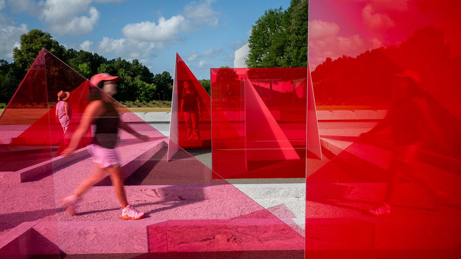 An eye-level shot of the Reds and Whites art installation on Centennial Campus, showing people strolling through the artwork.