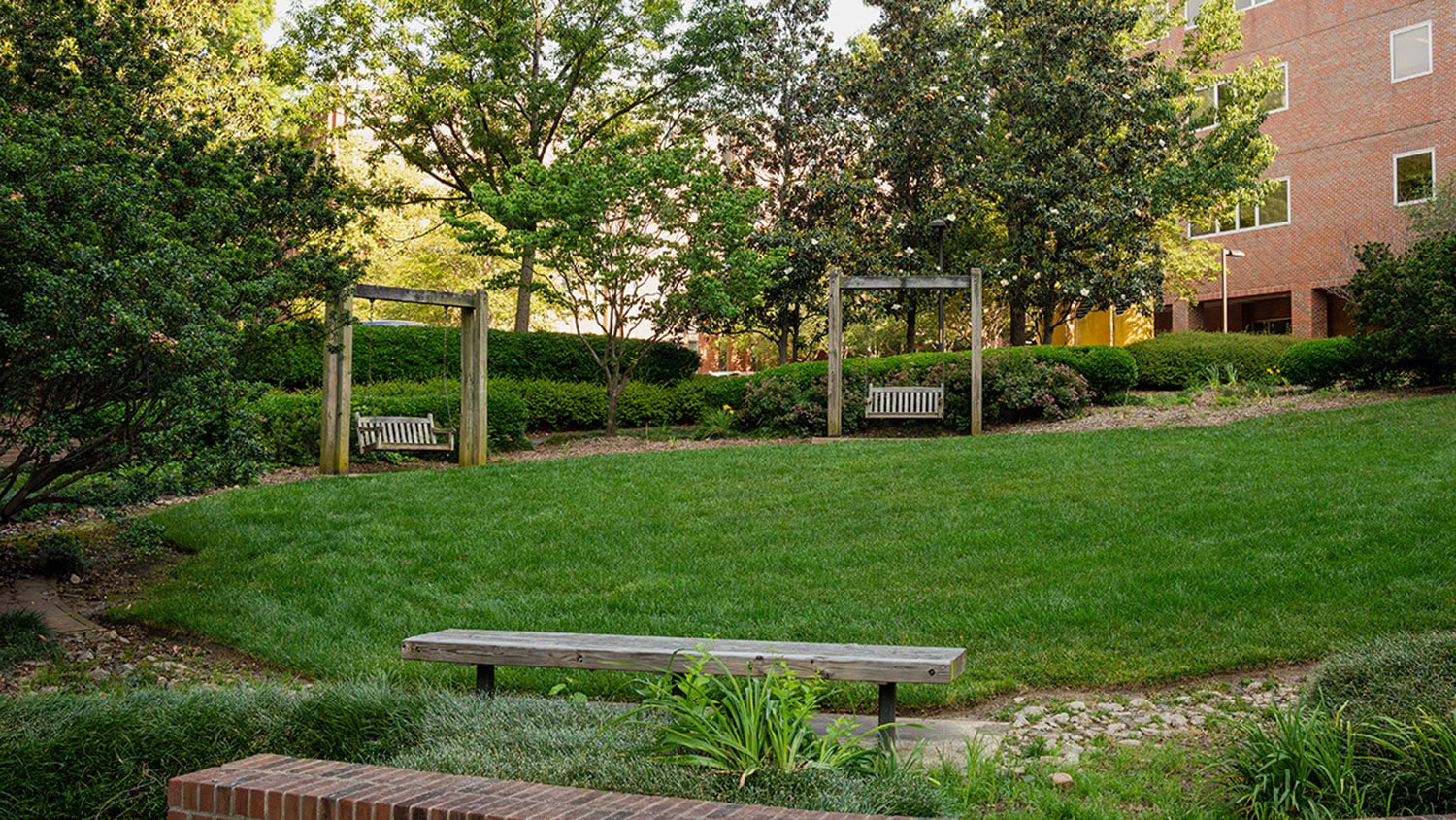 Two swinging benches at a courtyard on NC State’s campus.