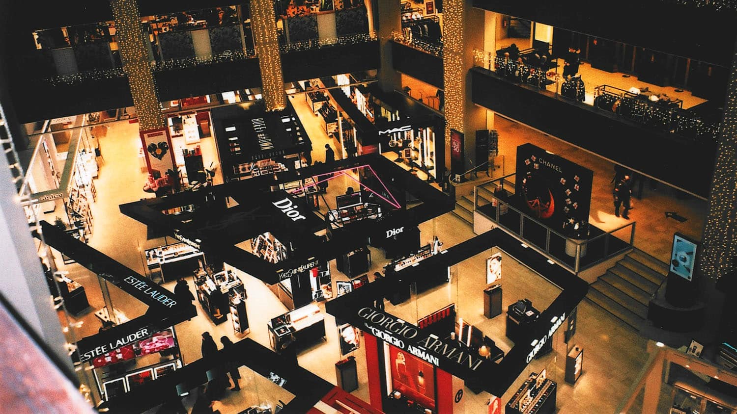 photograph looks down on a department store displays of luxury goods
