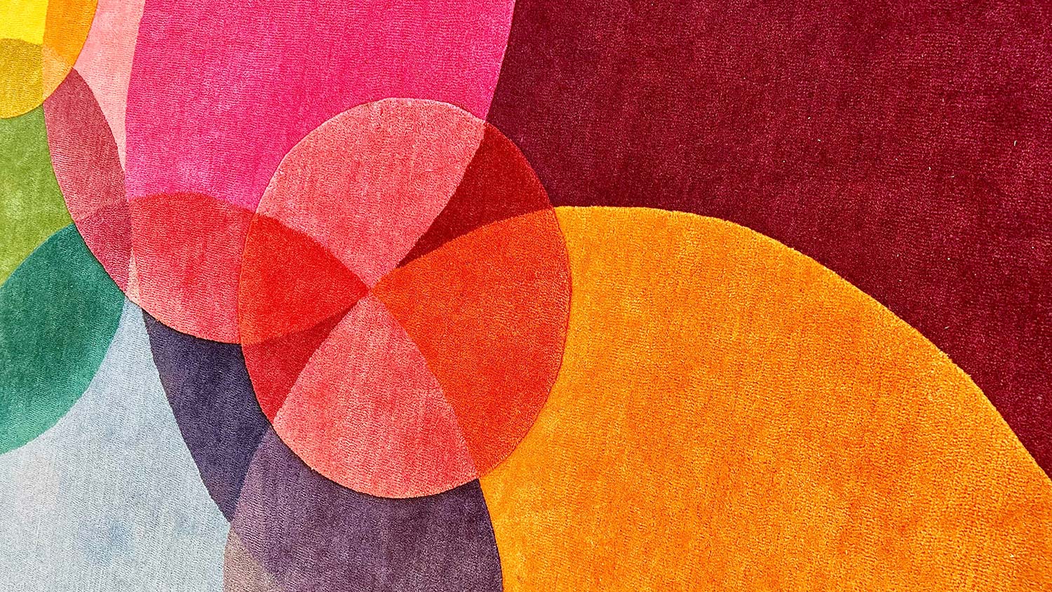 Close-up of carpet with overlapping circles in a variety of colors