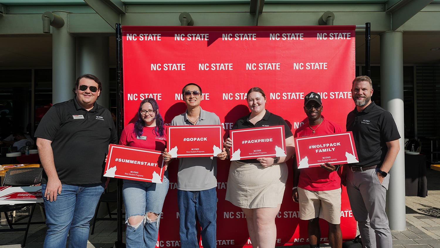 A group of staff members and new students pose together during a Summer Start event