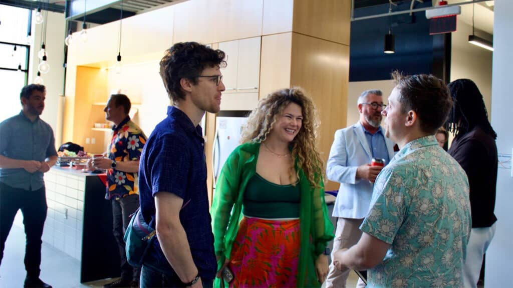 A group of people talk with each other at an event.