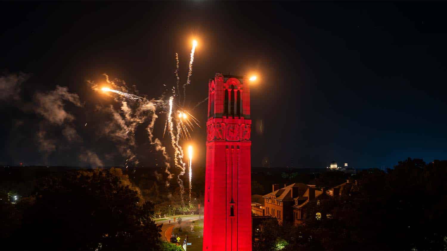 Fireworks erupt around the NC State Belltower during Packapalooza.